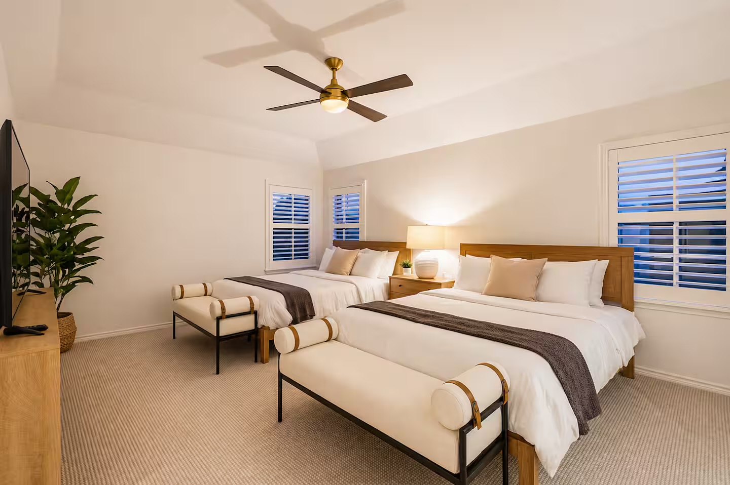 Spacious bedroom with plush bedding and natural light