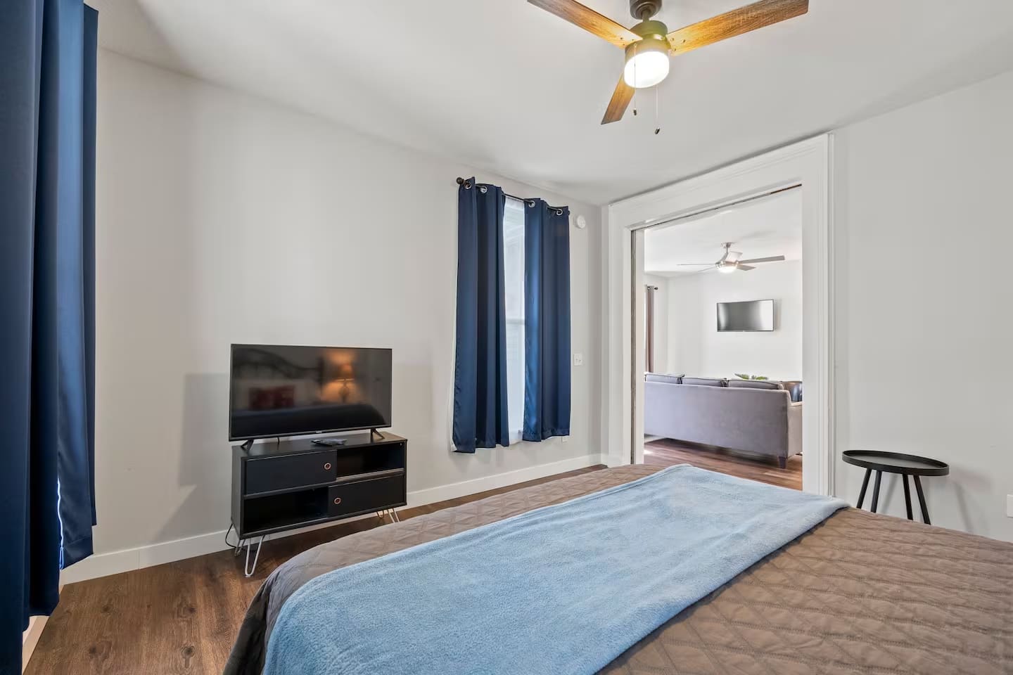 Comfortable bedroom with a TV and convenient access to the spacious living area, perfect for relaxation and entertainment.