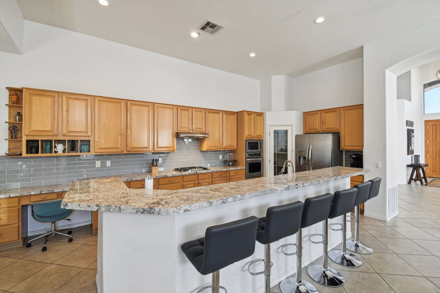 Whip up meals in the chef's kitchen with granite countertops, gas range, and stainless steel appliances — plus bar seating for five to keep the conversation flowing.