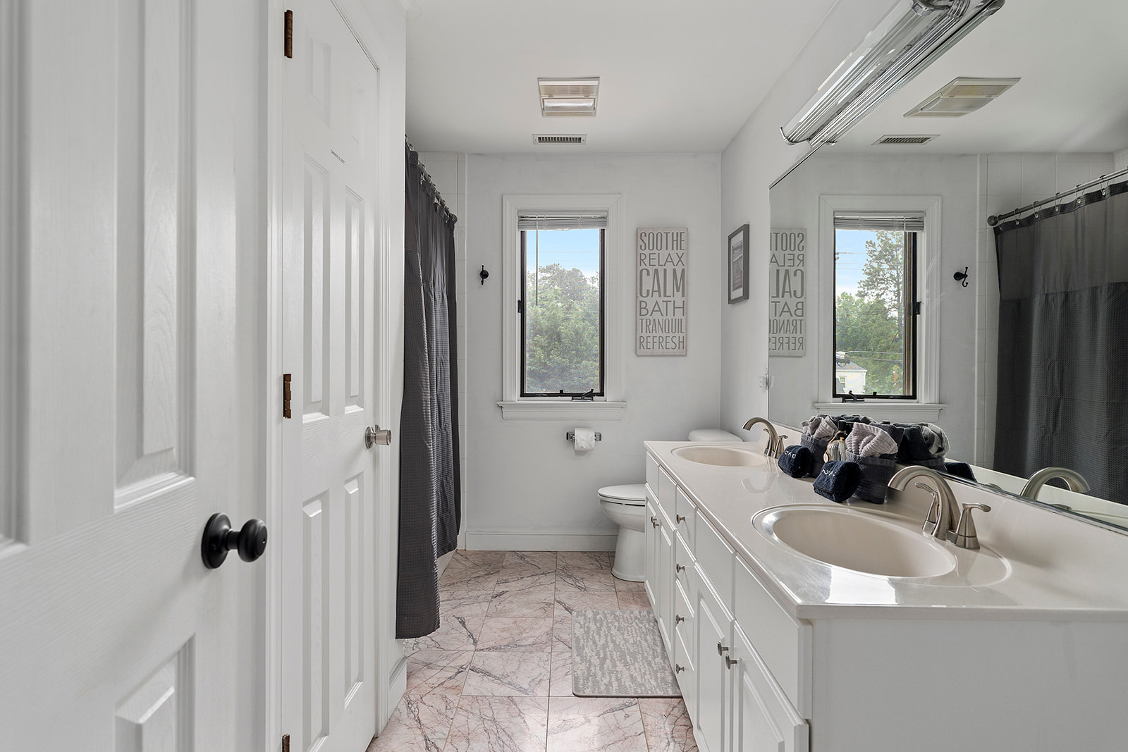 Full Bathroom 3: Bright, stylish retreat with double sinks and serene views for ultimate relaxation!
