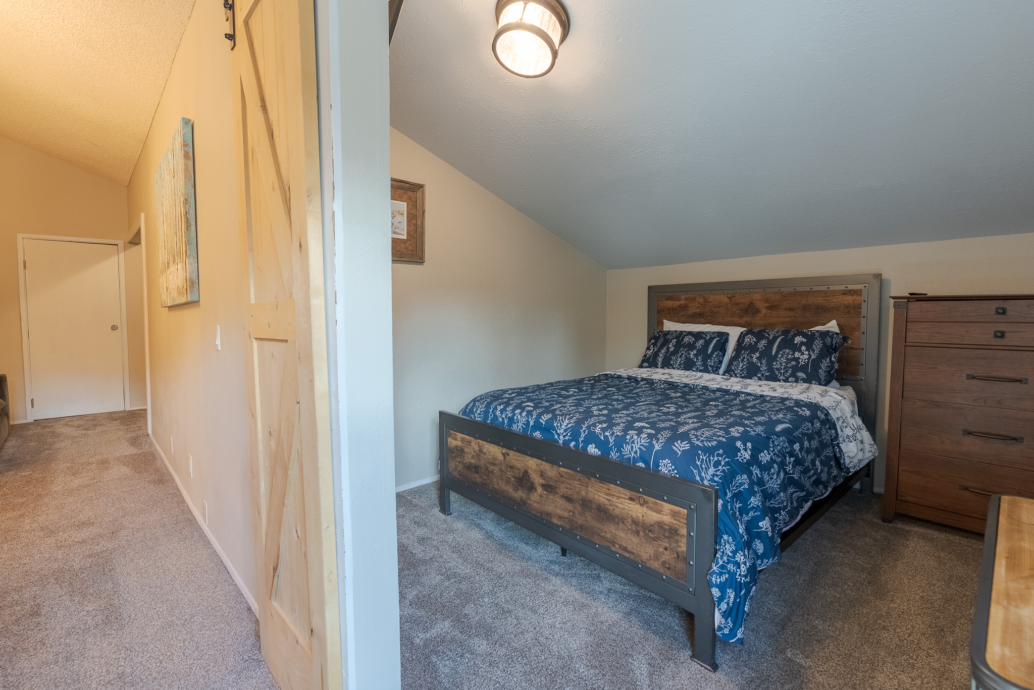 Upstairs queen bedroom, has a barn door to allow for partial closure.