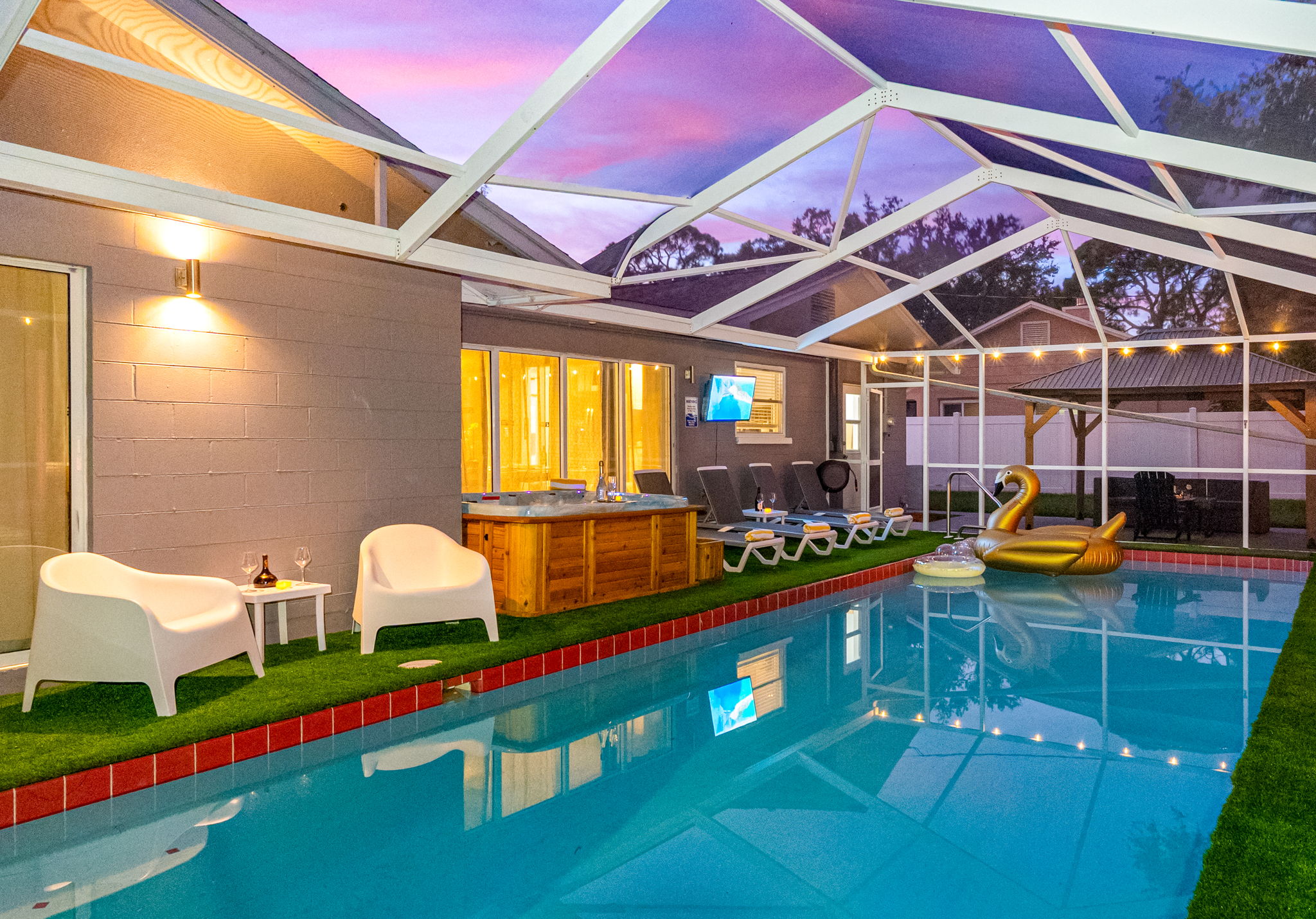 With glowing string lights, a swan floatie, and night-swim vibes, this screened-in pool is made for memory-making.