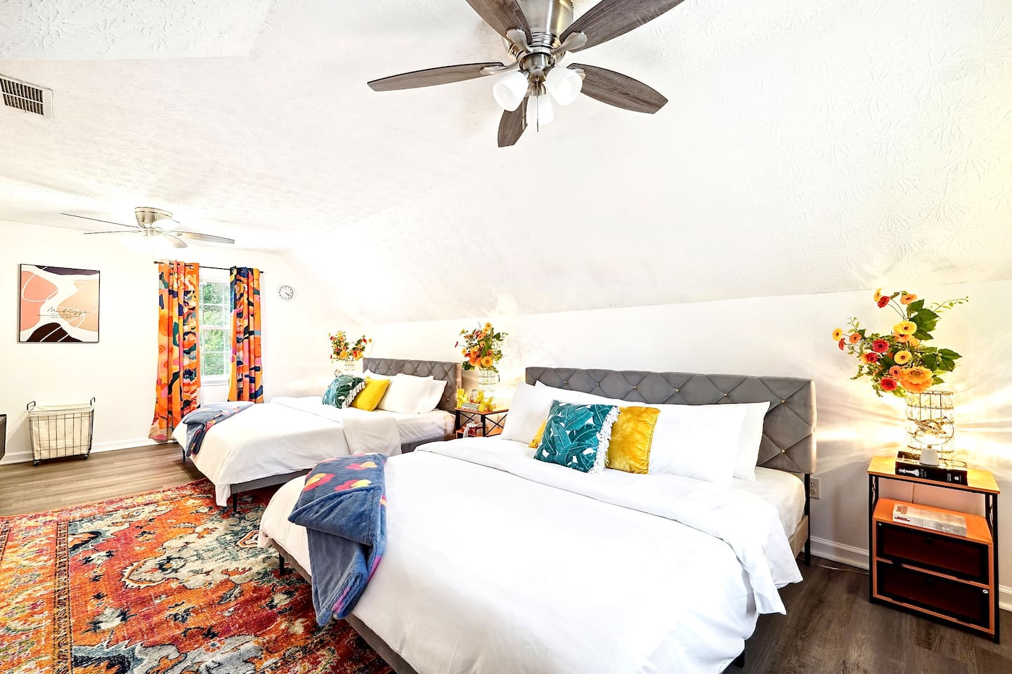 Bedroom 2 is located upstairs and features two king beds and a TV. This room does not have a private en-suite bathroom but has access to a shared full bathroom on the second floor.