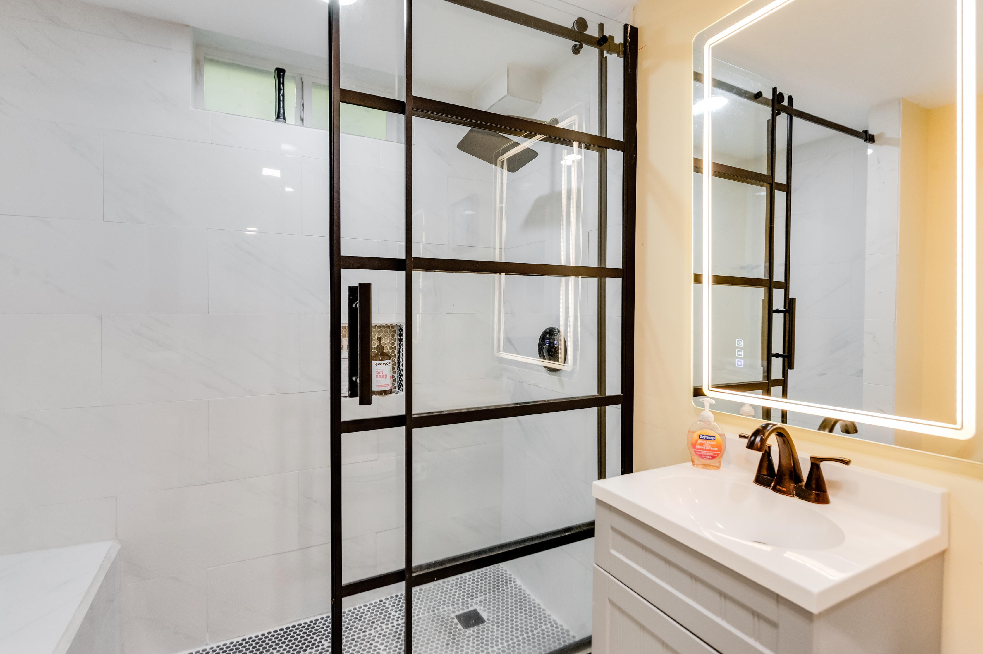 Downstairs Bathroom 3: Enjoy a rain shower and sleek vanity for a refreshing retreat!