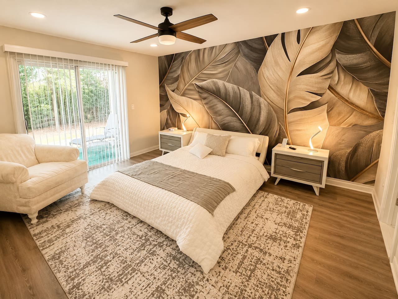 Bedroom with a queen bed and a comfortable sofa. 