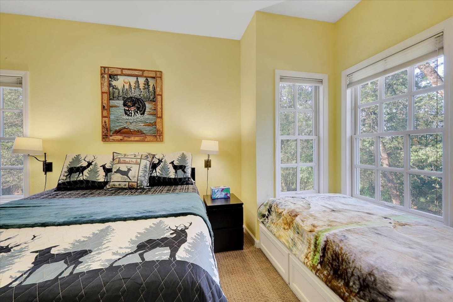 Bedroom 2 with a queen bed, twin bed, and rollaway twin for flexible sleeping space.

