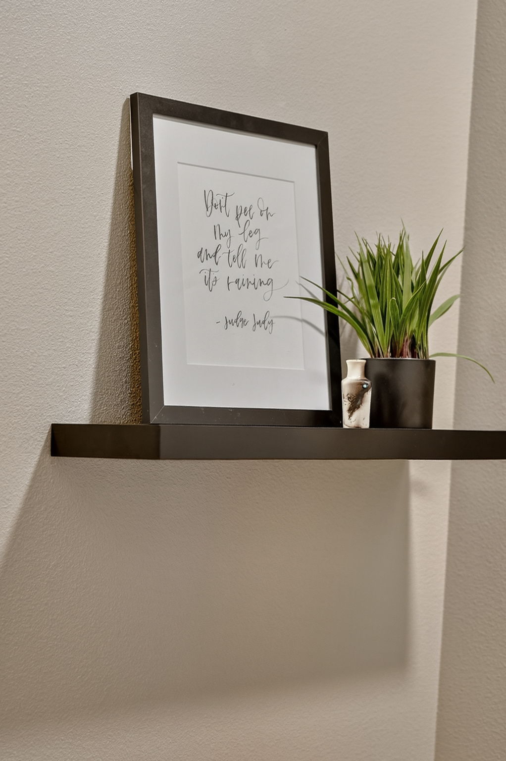 Minimalist artwork accents the bathroom space with color and design.
