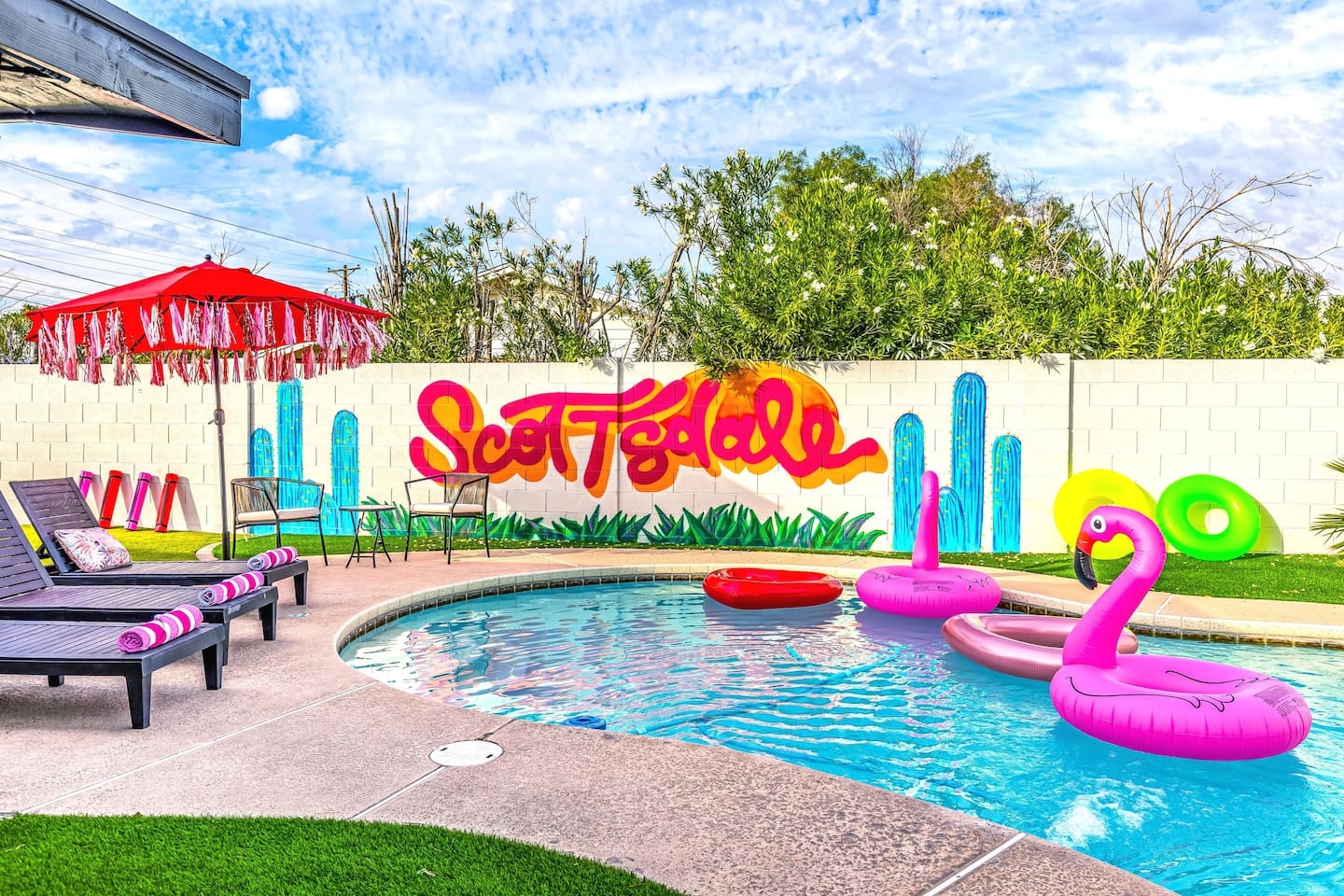 This backyard oasis isn’t just relaxing — it’s full of flair with bright murals, bold decor, and serious vacation energy.

