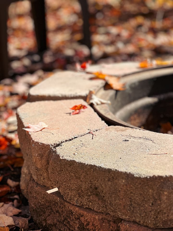 Cozy fire pit, with plastic chairs, perfect for relaxing evenings under the stars. Ample seating for everyone.
