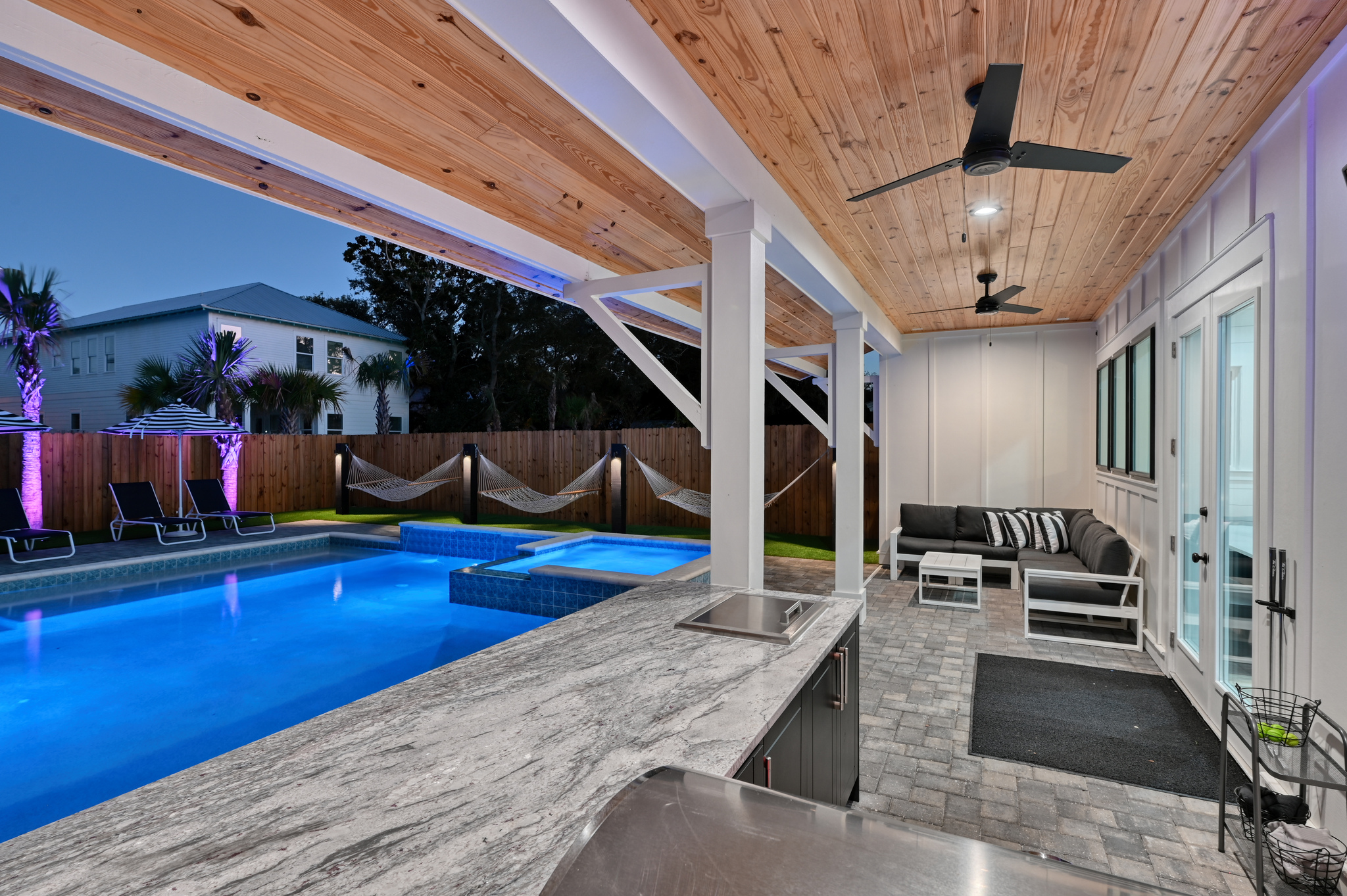 Extended covered patio with large L Shaped lounge and Summer Kitchen with grill, 50" Smart TV
