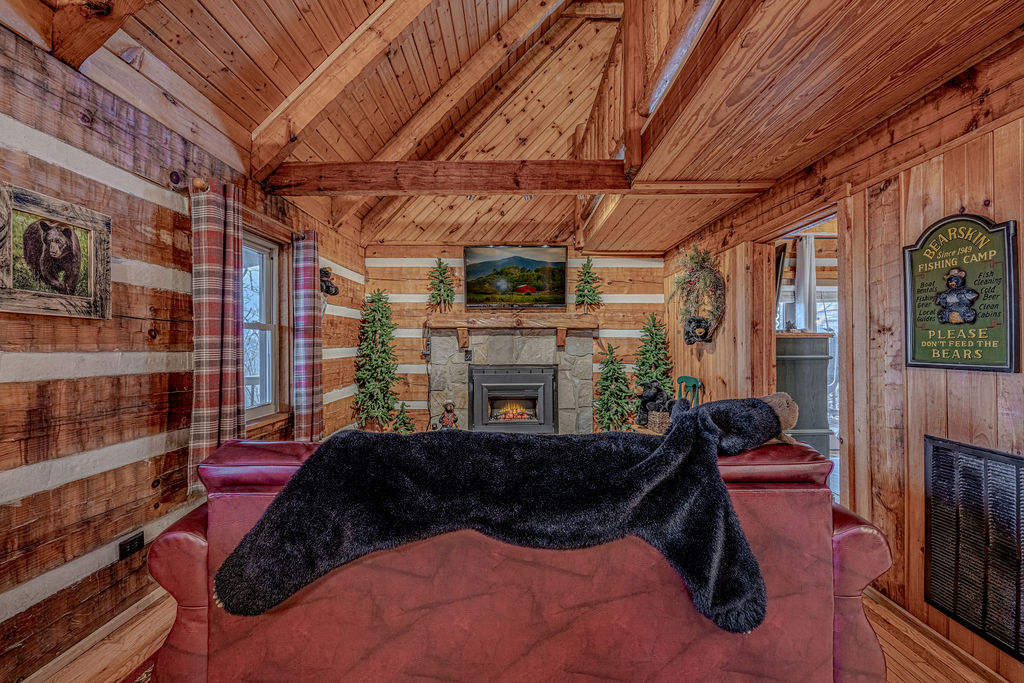 Open-concept living space with high wood-beam ceilings