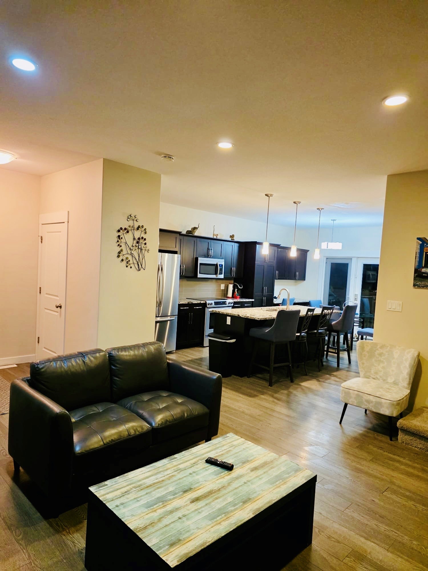 Modern open-concept kitchen and cozy lounge with island seating.