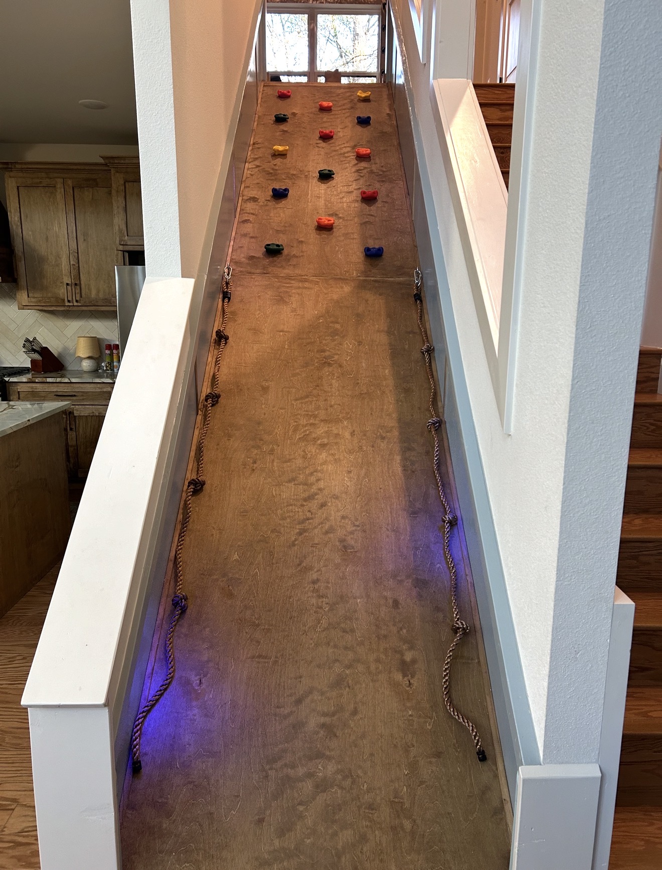 Unique indoor climb wall next to the staircase—an unforgettable feature kids love during their Broken Bow stay. 🌲🛝