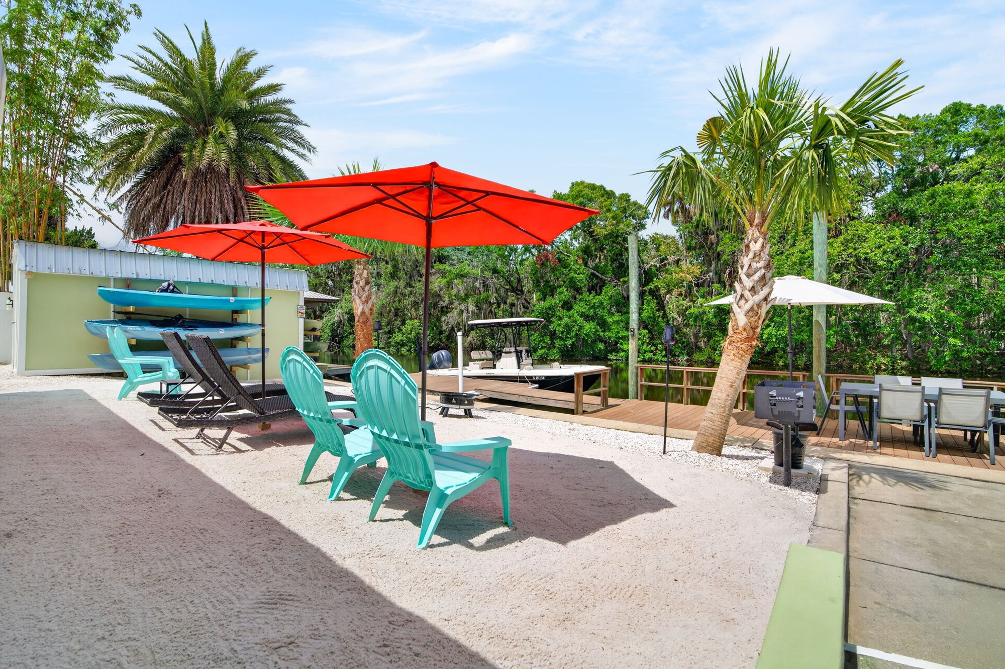 Beach seating with red umbrellas and fire pit