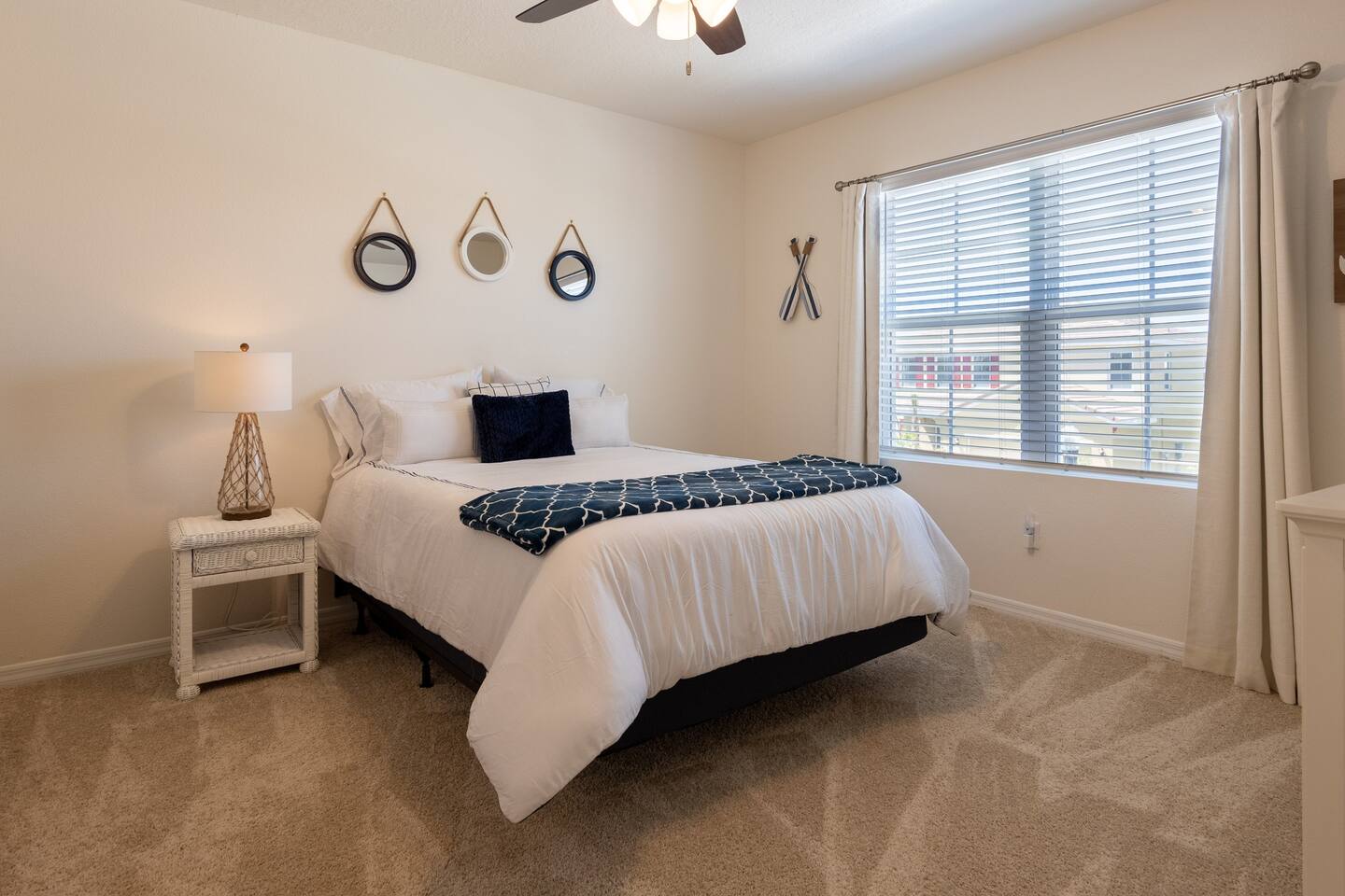 Upstairs Nautical Themed Room with Queen Bed.  Includes a 70 inch smart TV.  Luggage rack & laundry basket in closet.