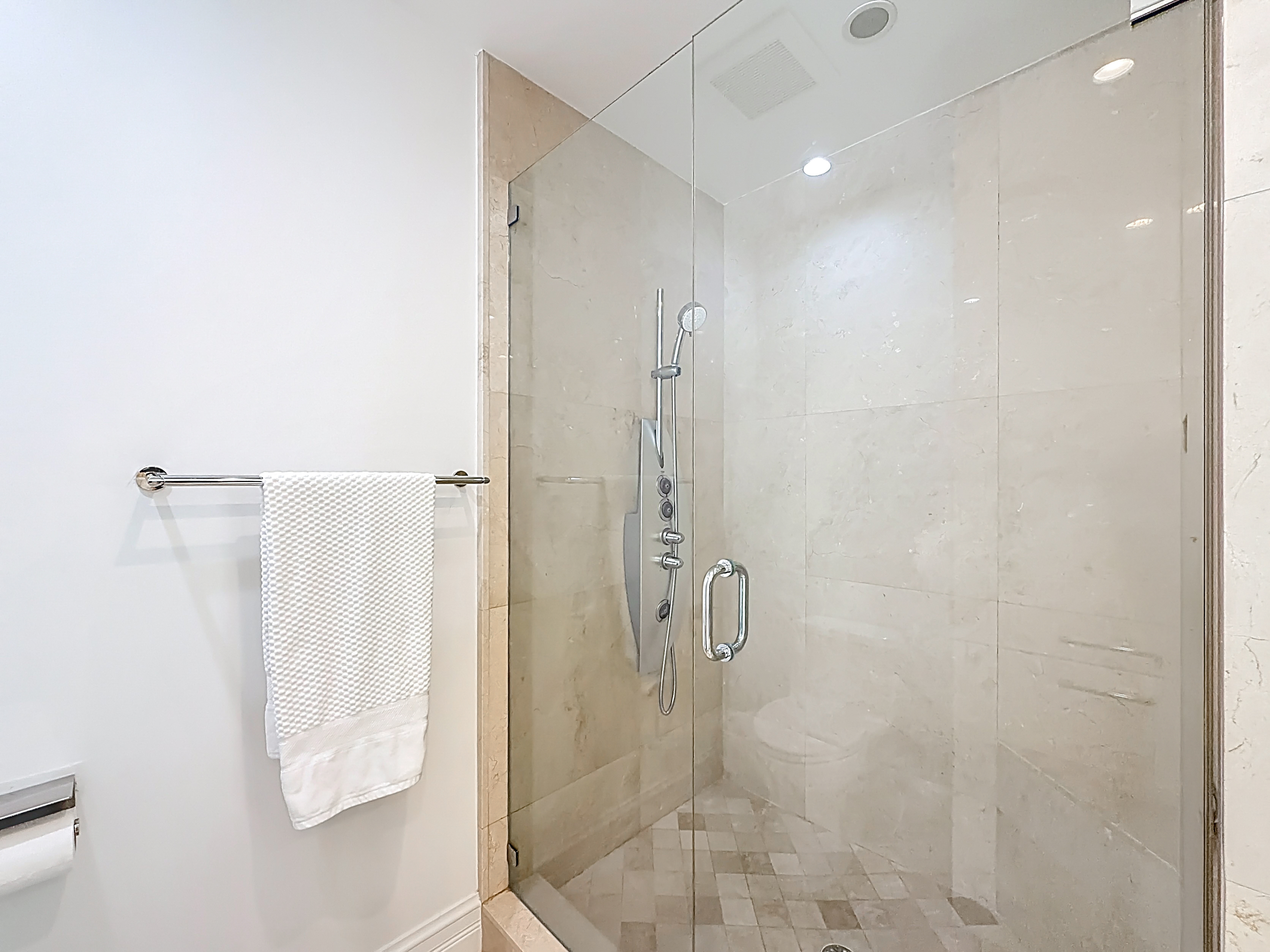 Large marble shower with body jets. 