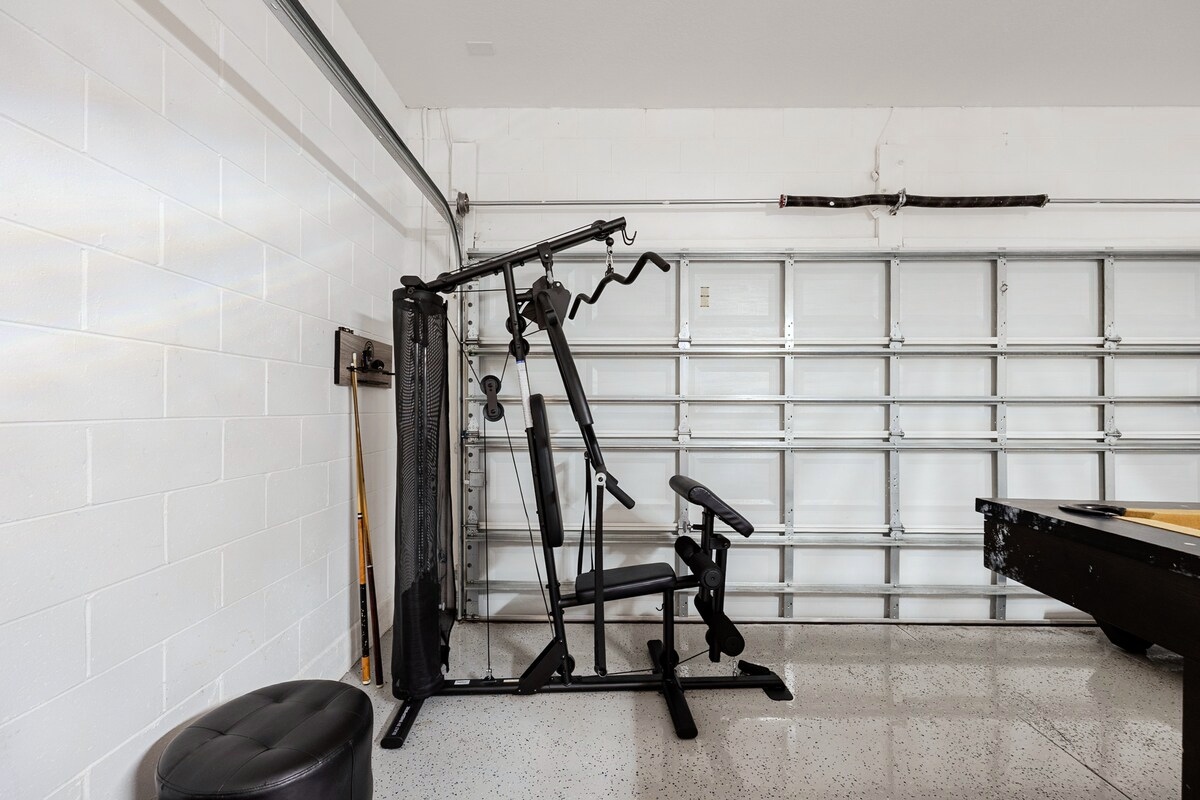 Multi-gym exercise equipment in the home’s private garage.
