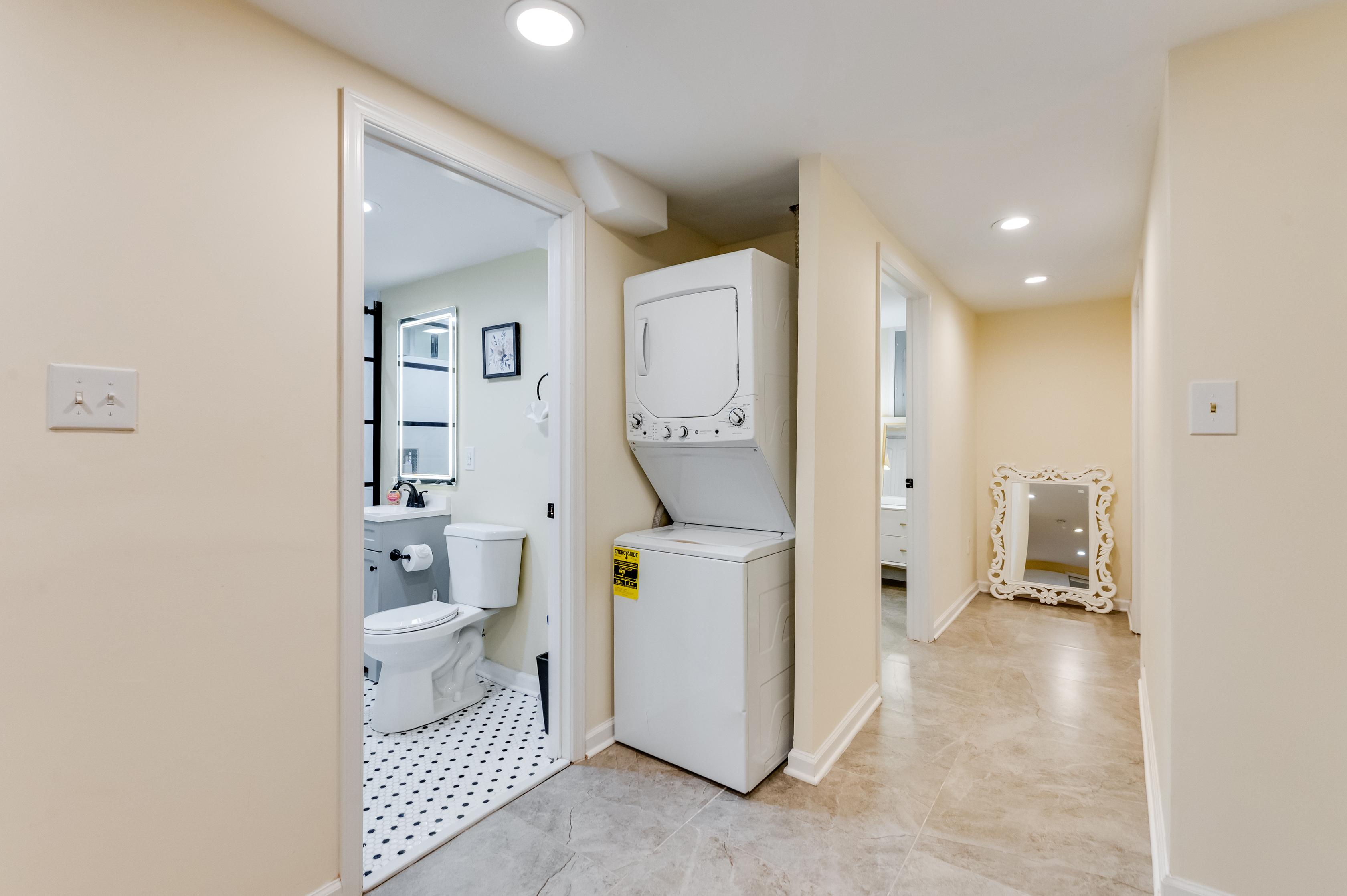 Downstairs Laundry and Full Bathroom 3: Convenient in-unit washer/dryer and stylish bath for ultimate comfort!