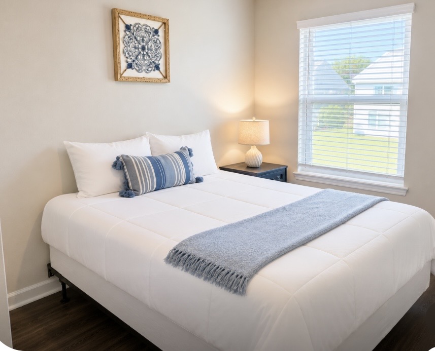 Rest easy in a serene bedroom with plush bedding, soft natural light, and relaxing coastal tones — a quiet, comfortable space for truly restful nights. ⭐