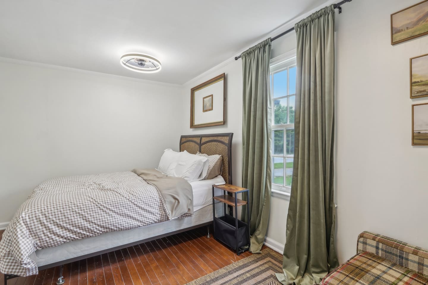 Bedroom 3 offers a comfortable queen bed, soft natural light, and a calm setup for a restful night.