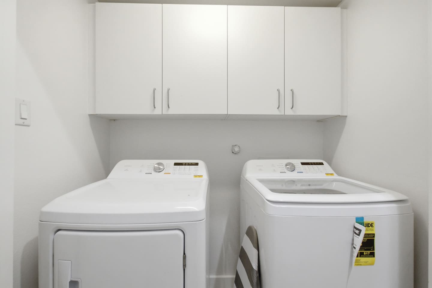 In-unit washer and dryer with overhead cabinetry and dedicated laundry space. A practical amenity that makes longer stays and light packing genuinely easy for every guest.

