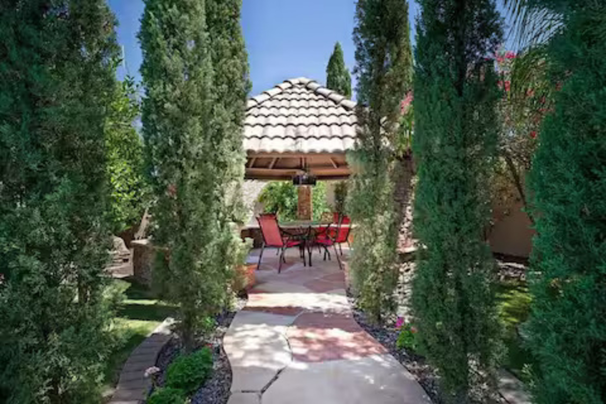 Stroll through lush greenery to a peaceful gazebo retreat, perfect for shaded dining, morning coffee, or quiet evening conversations.