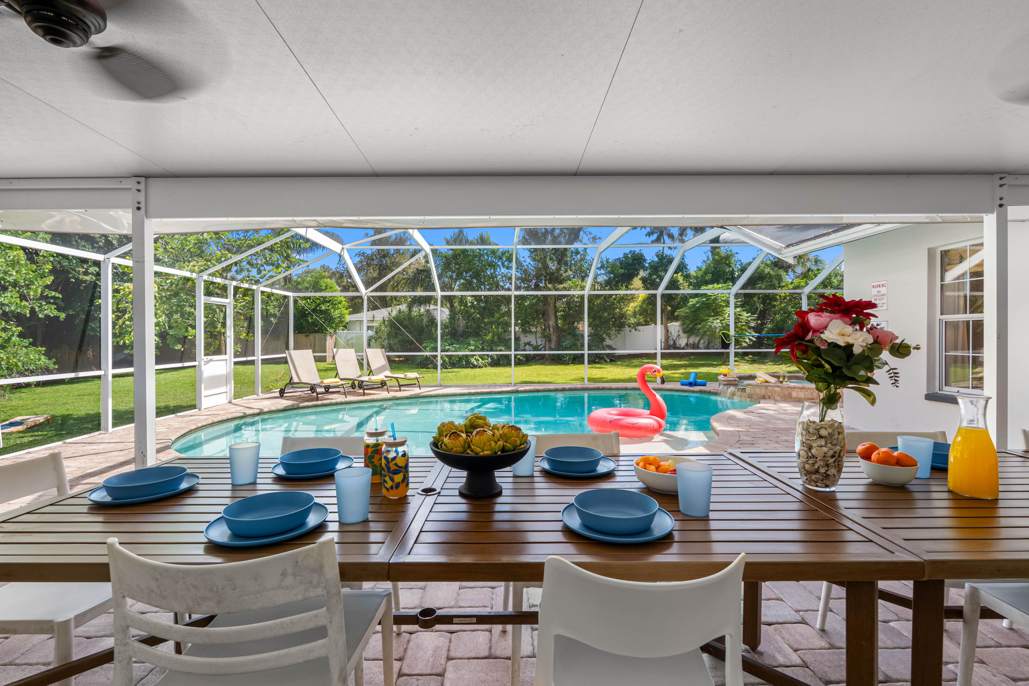 This outdoor oasis boasts a large screened enclosure with a resort-style pool and plenty of seating for guests.