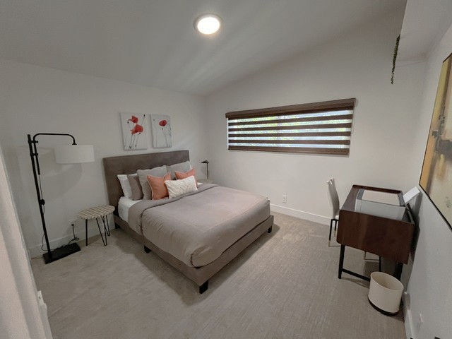 Guest Queen bedroom with large closet, desk with printer, and private courtyard view.