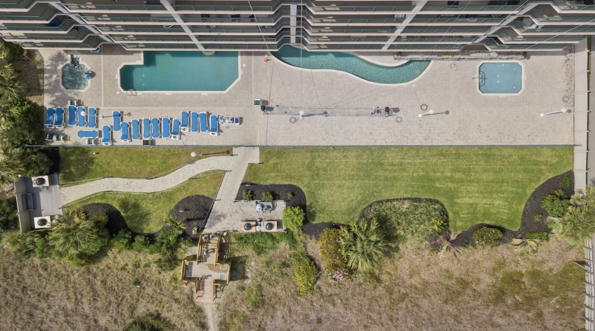 Looking down from the penthouse balcony, you can see the Windy Hill Dunes pool, lazy river, and hot tub.