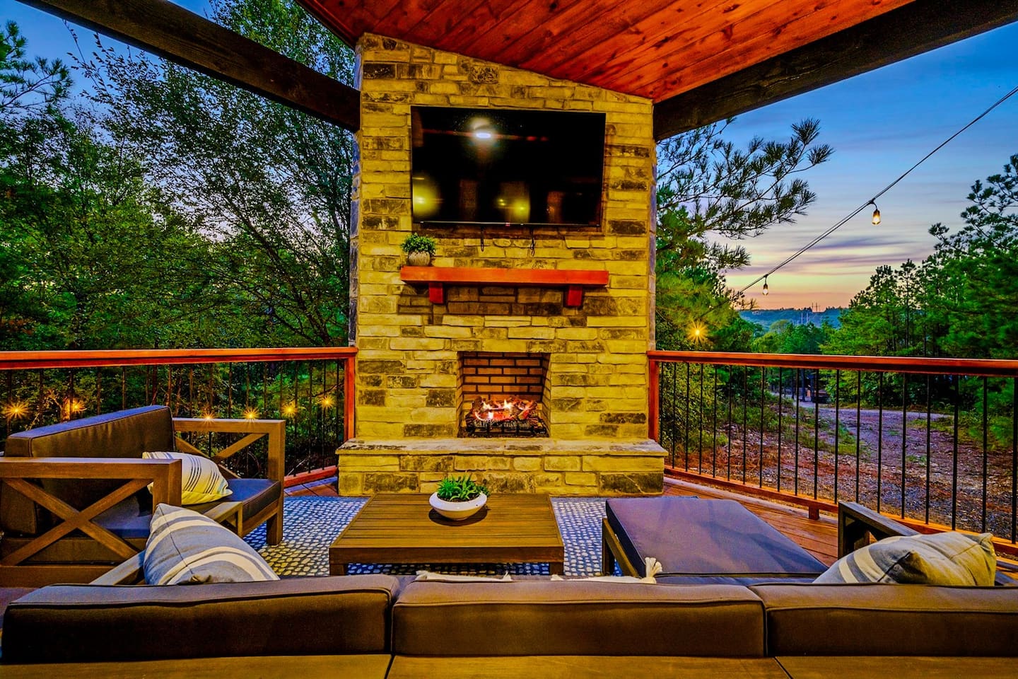 Amazing outdoor patio with TV, gas fireplace, and living and dining spaces.