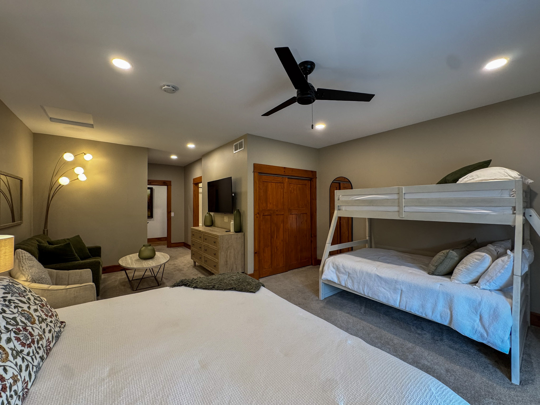 One of our two Jack and Jill bedrooms, each with a king bed and a queen-and-twin bunk bed. The two rooms have matching, mirrored layouts.