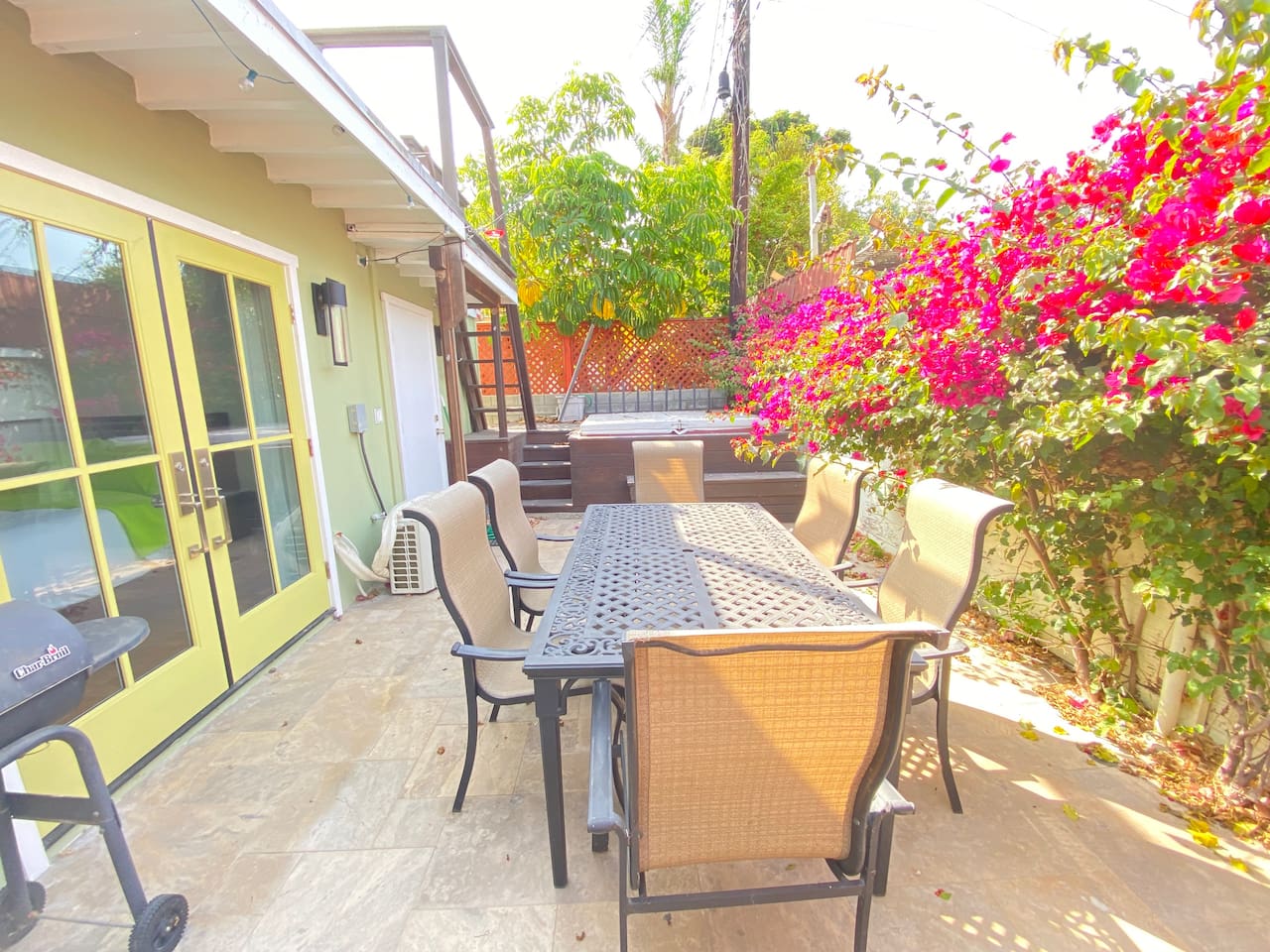 Private garden patio with outdoor dining for six. A bright, peaceful space surrounded by bougainvillea.