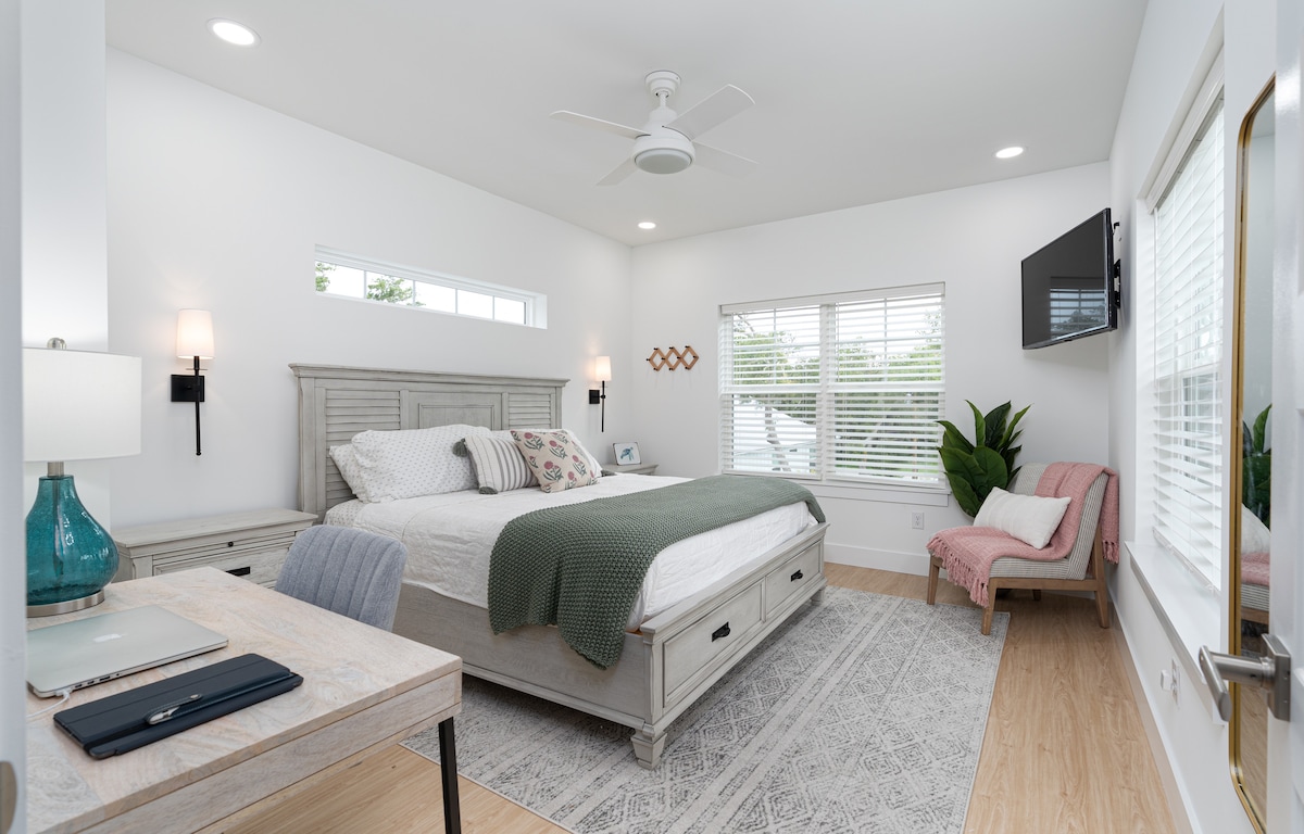 Upstairs, the second king suite runs the width of the house. There is a real desk by the window if a workday sneaks into the trip, a TV for the ones who wake up last, and a bathroom of your own through the door.