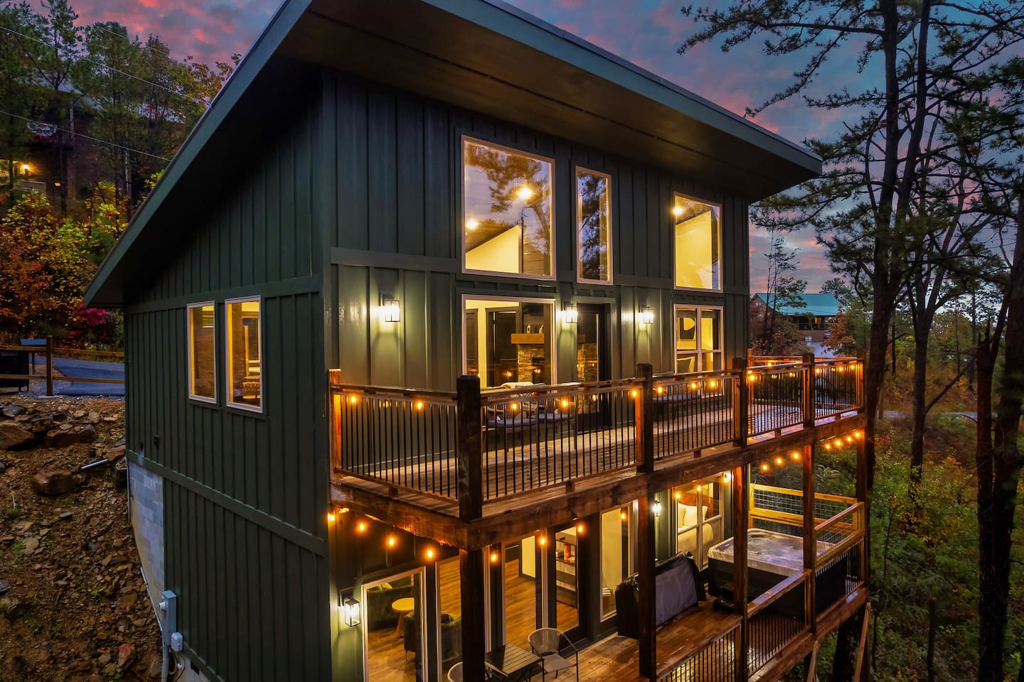 Evenings at Sunset Ridge — glowing decks, forest views, and a private hot tub.