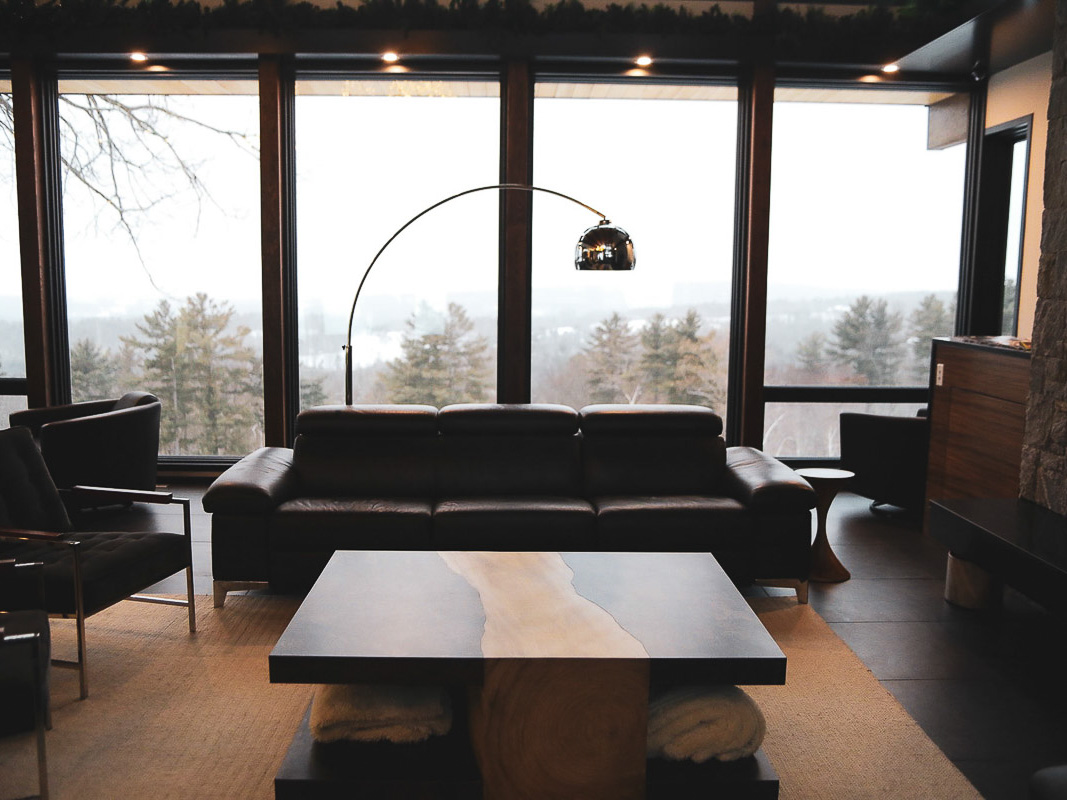 Snowy late-afternoon valley view across the living room sofa &mdash; Sunset Falls Berkshires