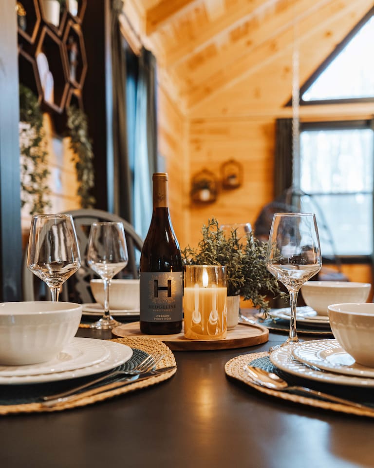 Intimate dining framed by natural timber and shifting forest light