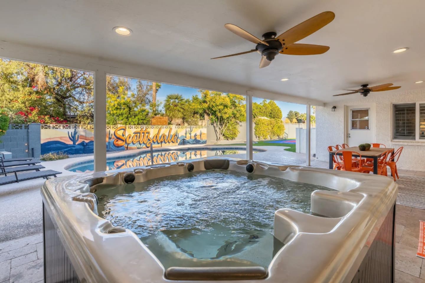 Soak away the day in the private hot tub, tucked under a shaded patio with ceiling fans keeping things comfortable even in the Arizona heat. The mural in the background says it best: this is Scottsdale.