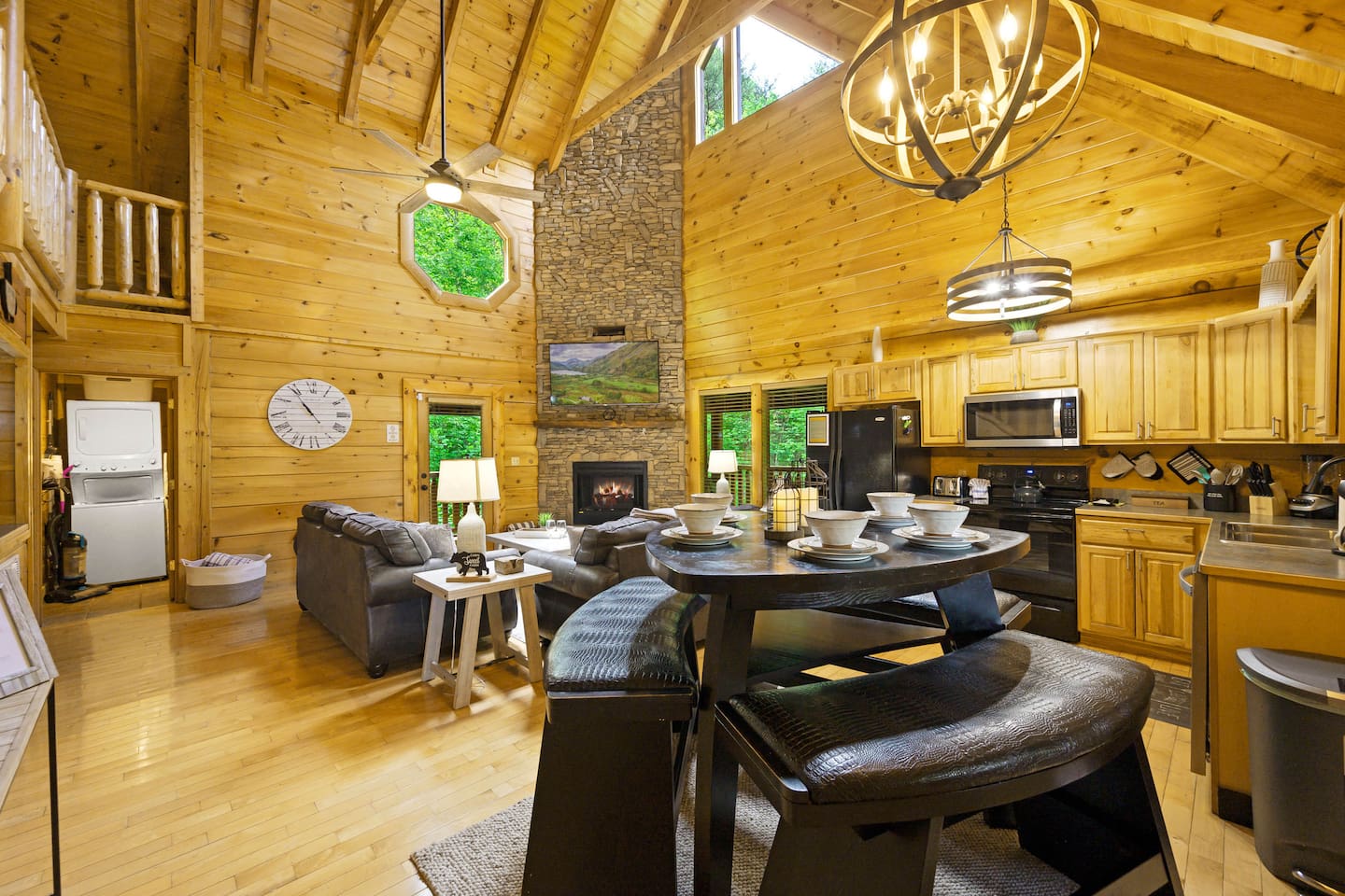 Step into the large open concept kitchen, dining area, and living room with captivating vaulted ceilings.