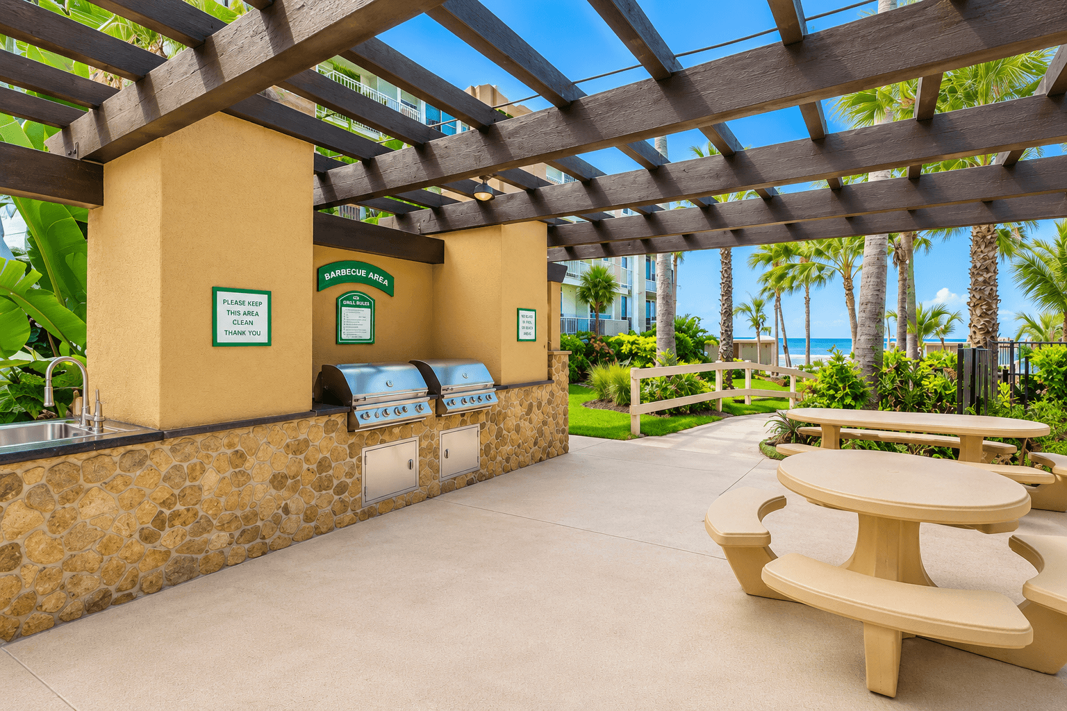 Community barbecue area overlooking the pool and ocean