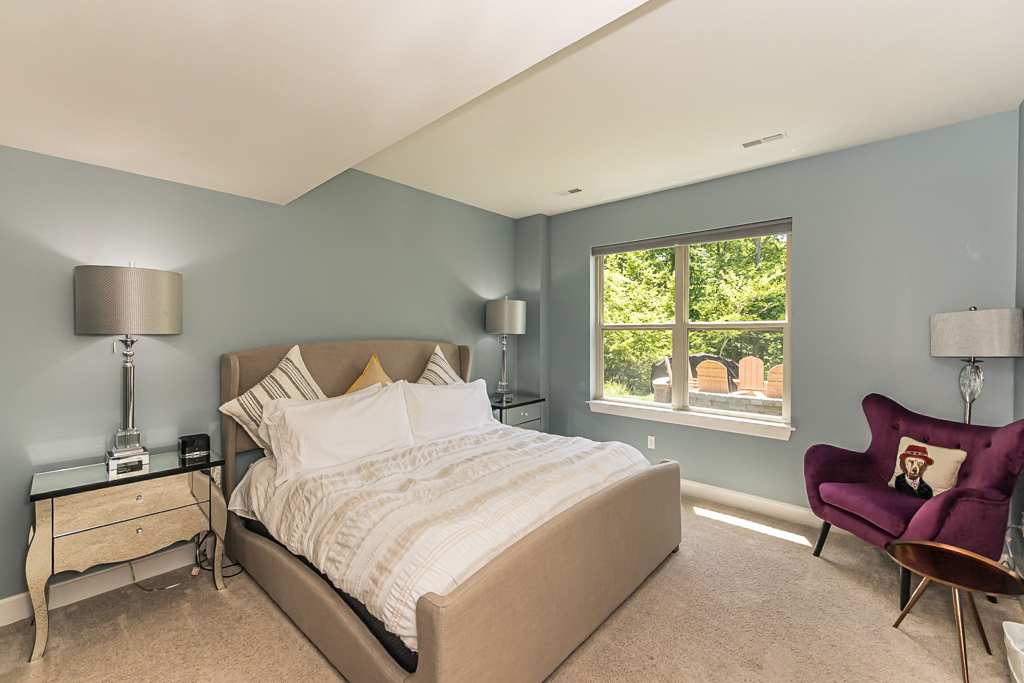 Another spacious king bedroom with comfortable seating.