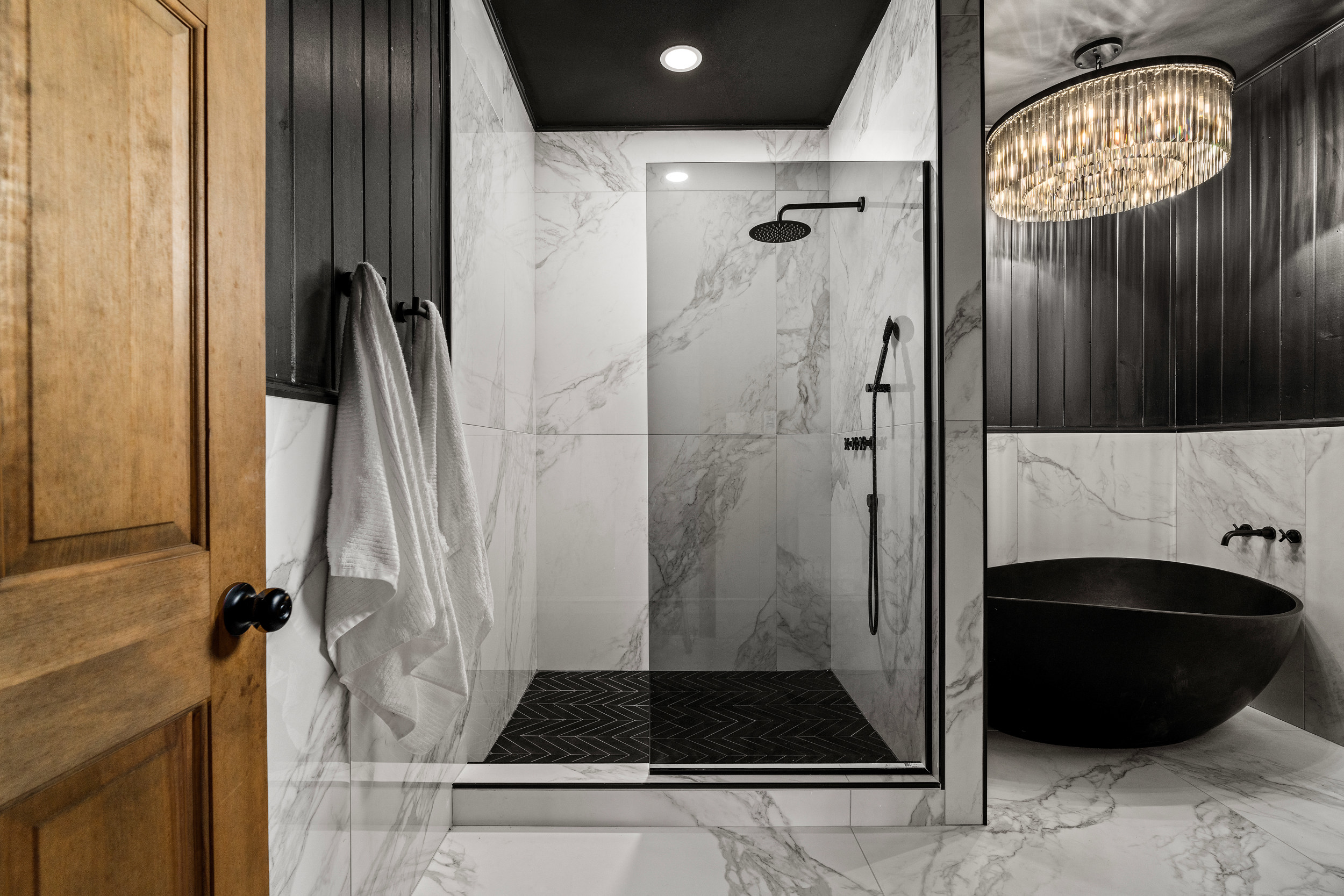 Luxurious Bathroom Retreat: Indulge in sleek marble finishes and a stunning freestanding tub!