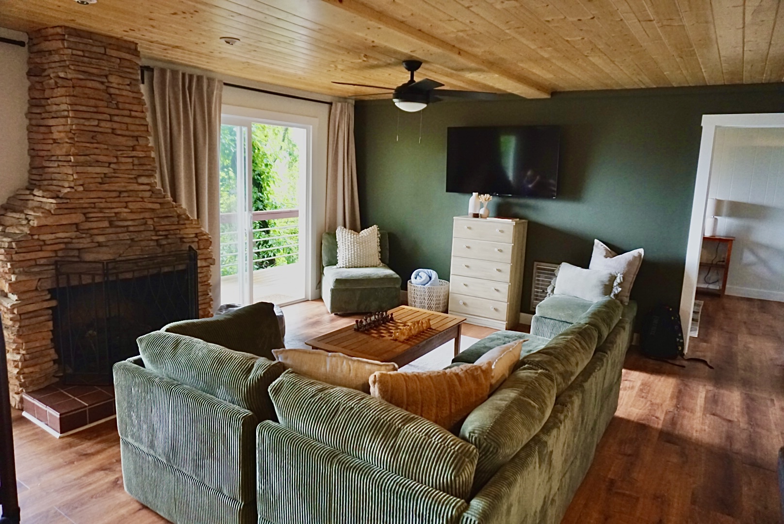 Living Room: Relax by the stone fireplace and enjoy nature views from the spacious balcony!