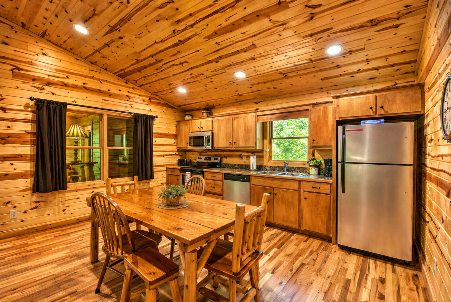 Cozy cabin dining meets a fully equipped kitchen—warm wood tones, vaulted ceilings, and the perfect space to gather, cook, and unwind.