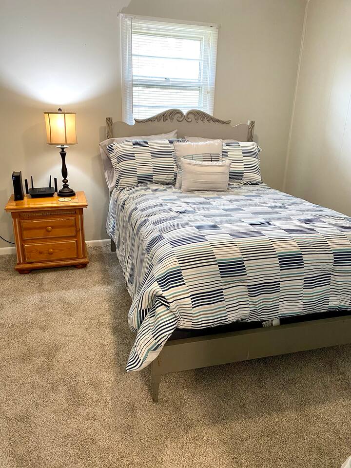 A secondary queen bedroom with a full closet