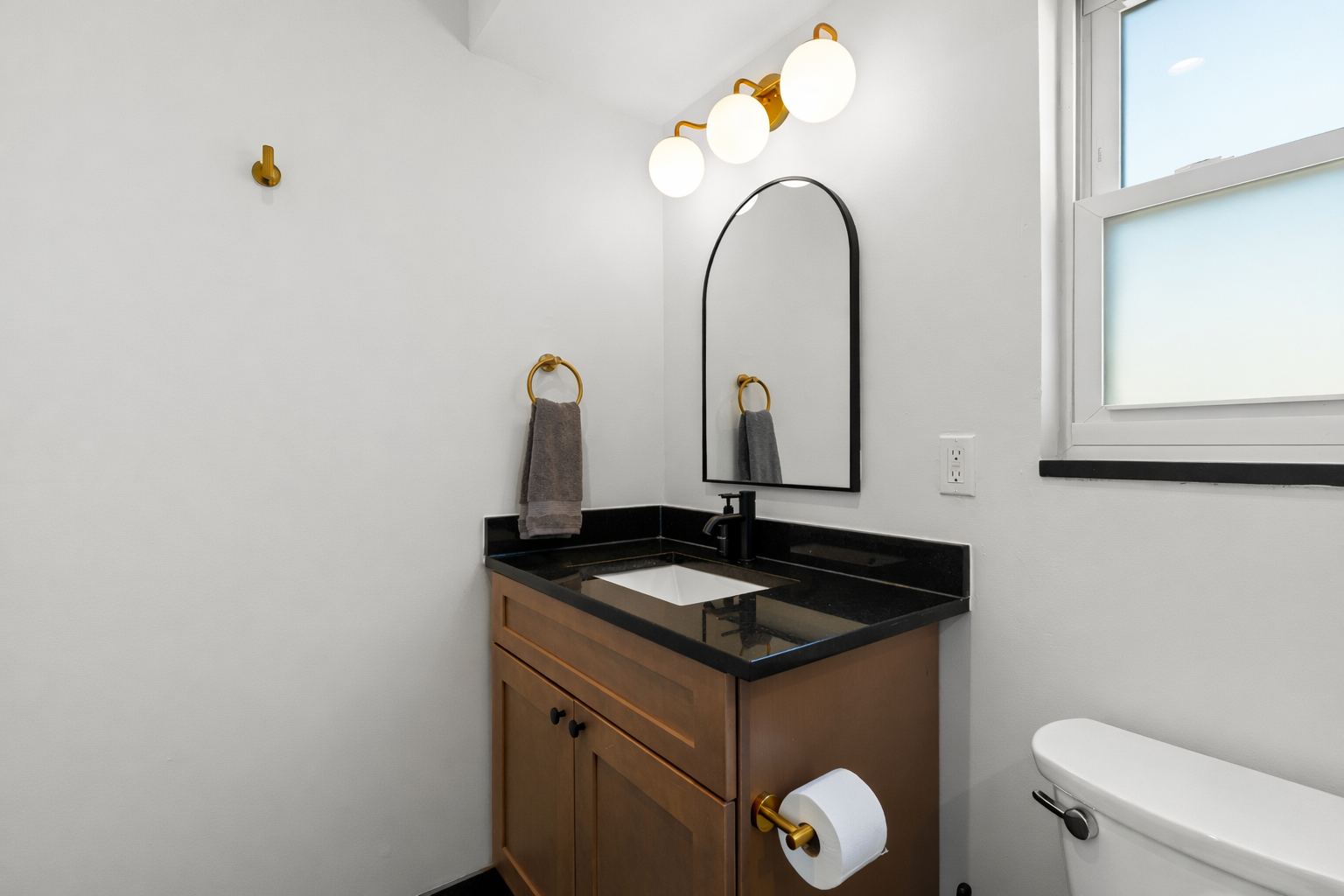 Modern bathroom vanity with sleek finishes, soft lighting, and thoughtful details—creating a clean, calming space to refresh and unwind.