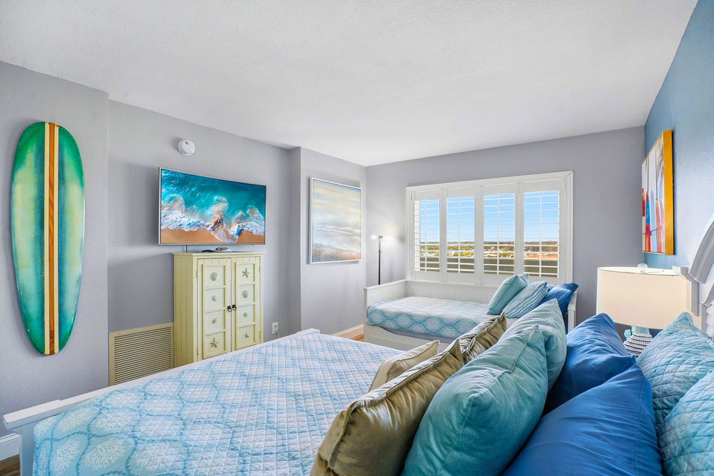 Spacious coastal bedroom in this beachfront vacation rental featuring Queen and Twin trundle bed.