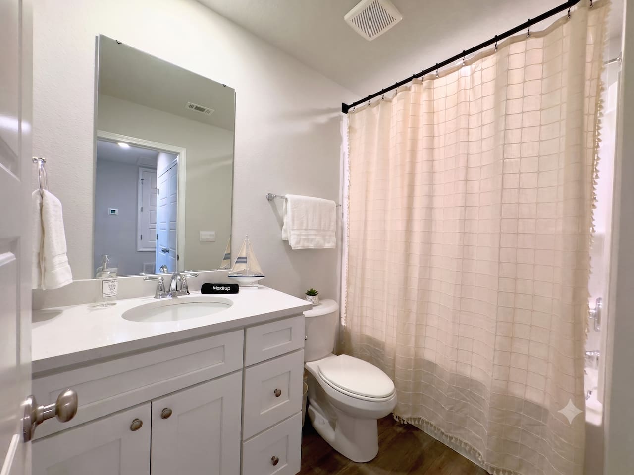 Warm water waits behind the curtain, cool counter beneath your hands as you get ready. Soft light through the window. Simple, tidy, easy to move through.