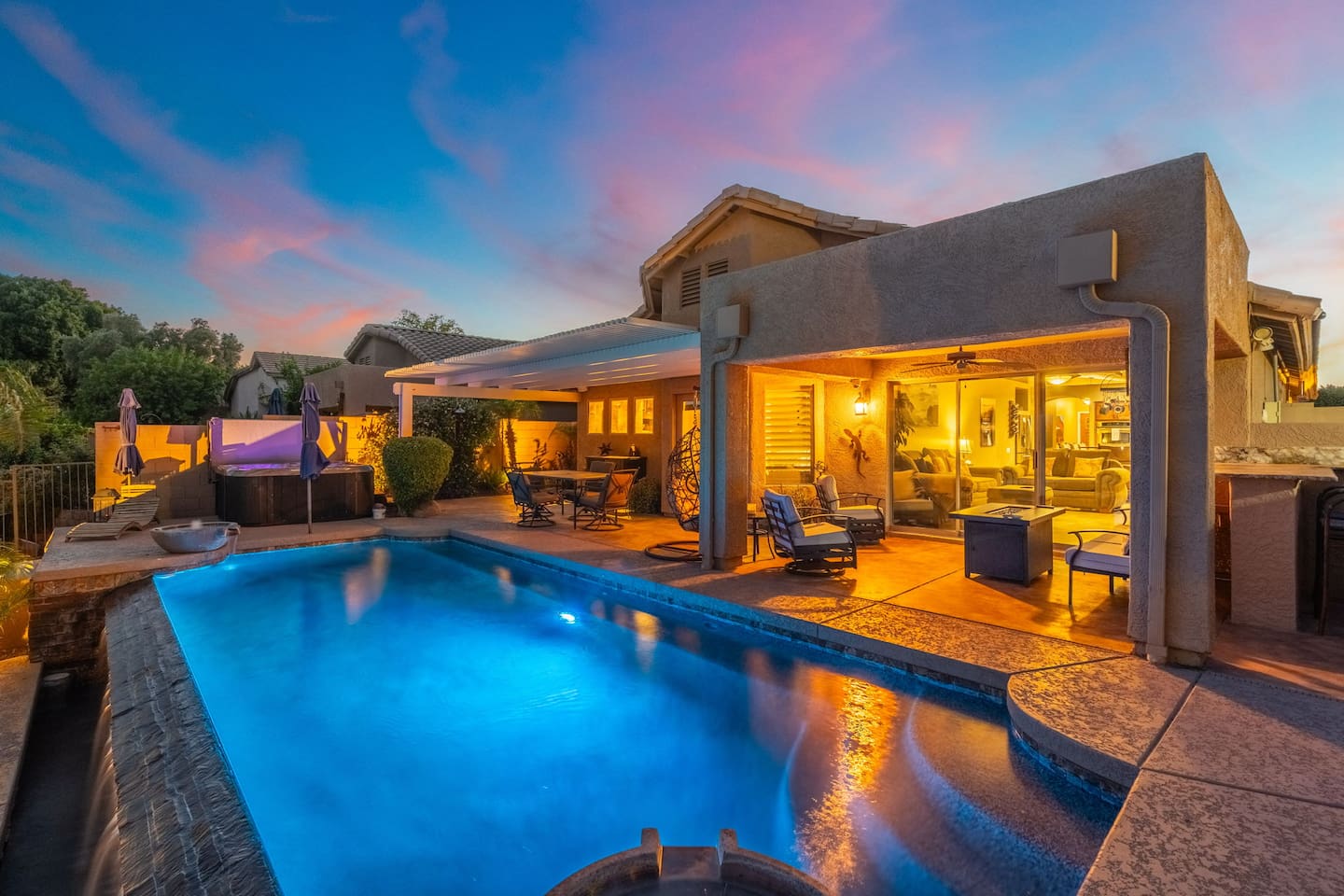 As the Arizona sky turns pink and gold, the pool lights up and the covered patio glows warm — this is the backyard moment you'll keep coming back for.