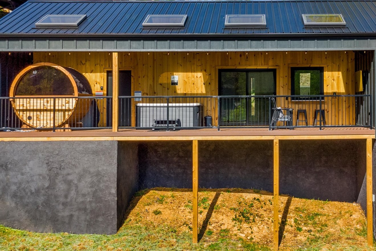 Another view of the expansive back deck with sauna, hot tub, outdoor bar and TV