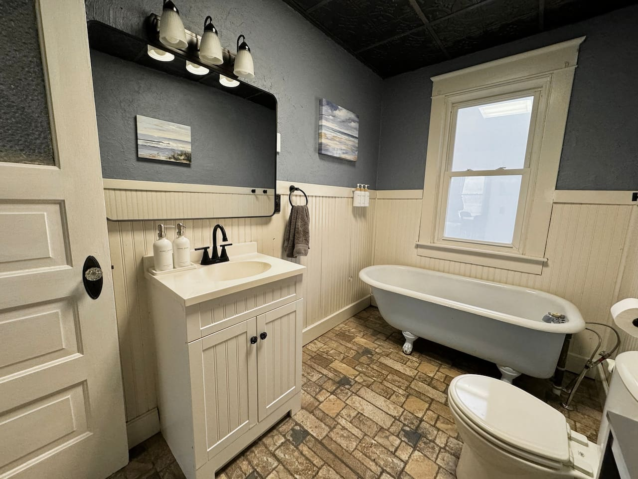 Main Level Bathroom - Relax in the vintage clawfoot tub. (Note: This bathroom features a tub only, no shower).